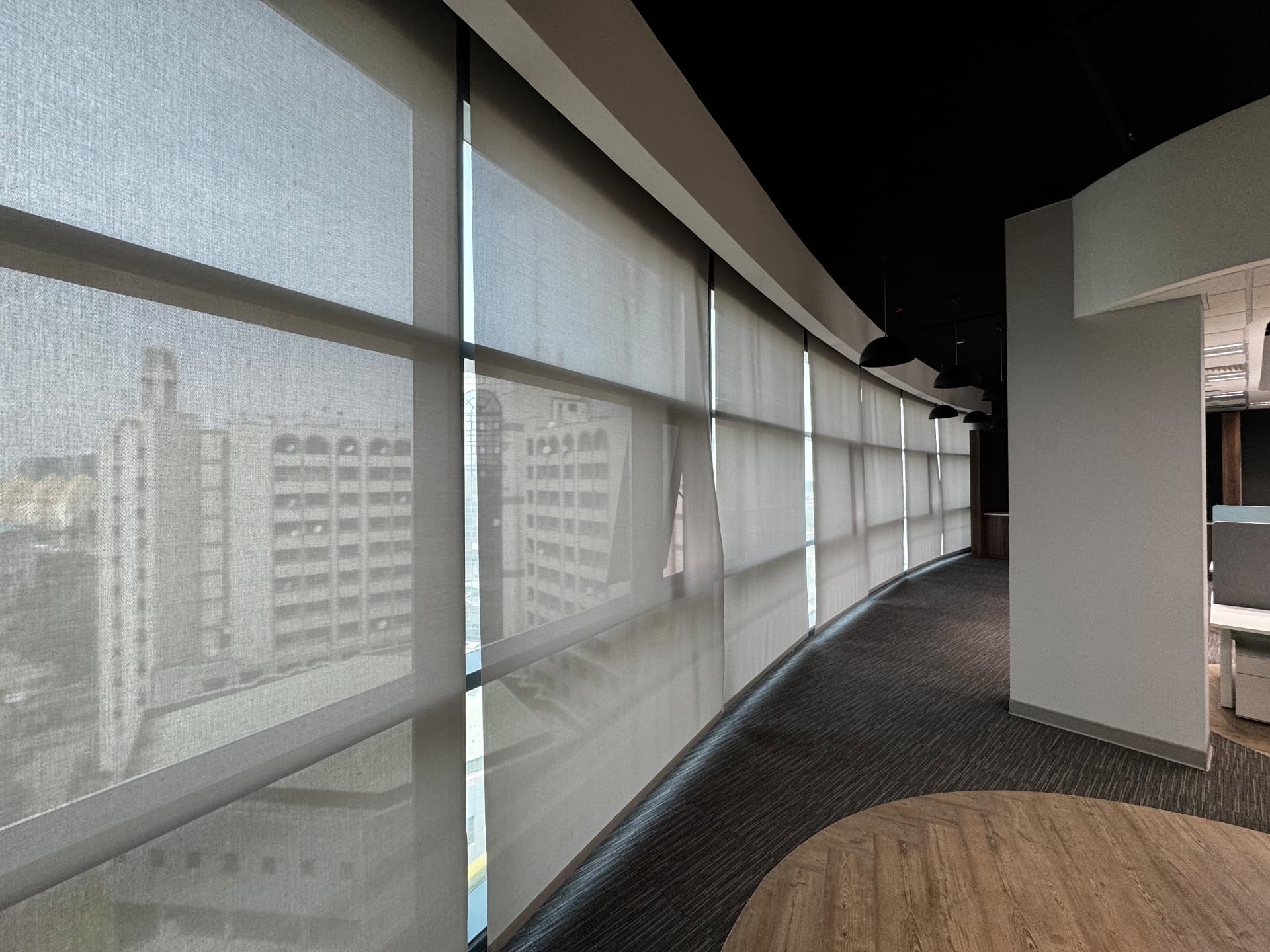 Sunlit office corridor fitted with MShades roller shades
